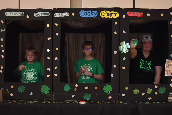Three male youth with 4-H clovers