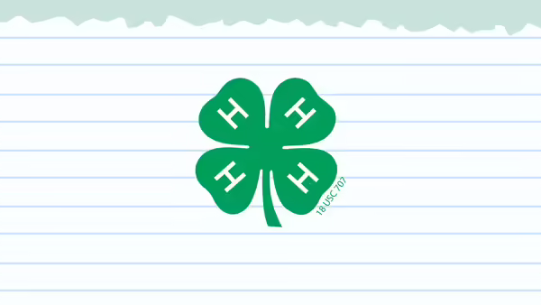 A ripped page of lined notebook paper on a mint color background. A green 4-H clover is in the middle of the lined paper.
