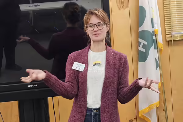 a lady presenting in front of room
