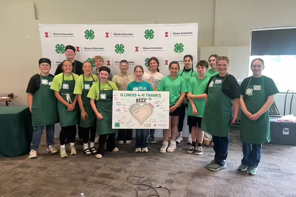 Participants pose with a thank you sponsor sign.