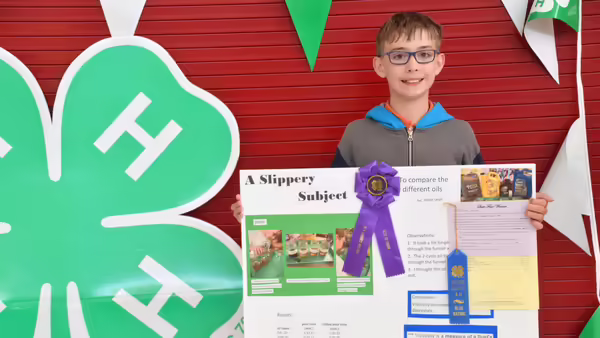 a boy holding a 4-H project