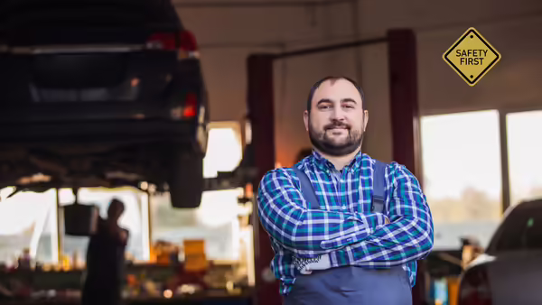 a mechanice standing in front of a car
