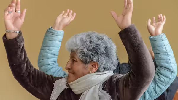 Older woman hands raised above head