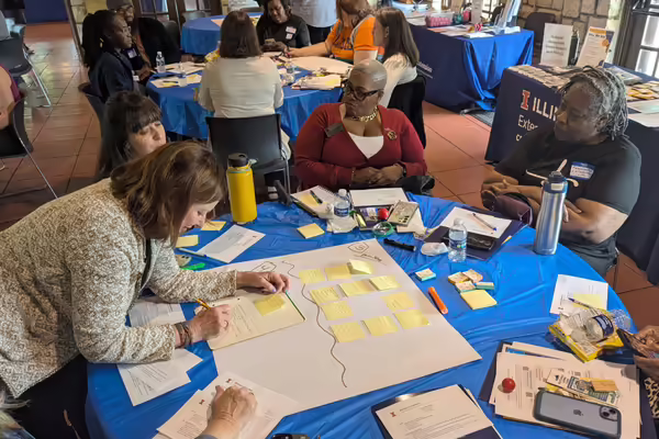 program participants working together at a circular table