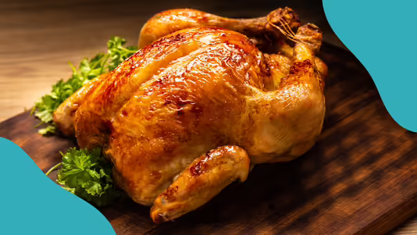 a whole roasted chicken on leafy greens
