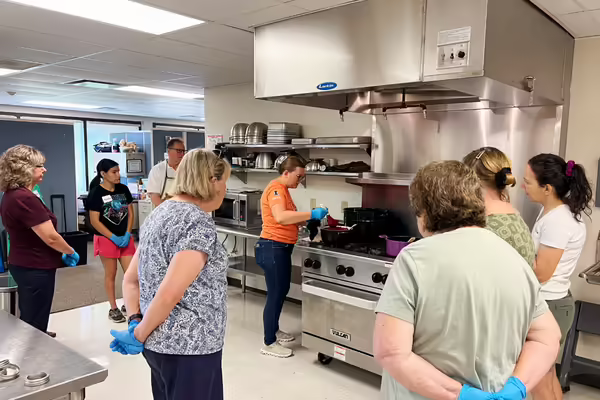 Educator demonstrating jam making to an audience