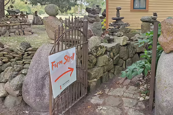 iron rusty fence with stone and stone pathway