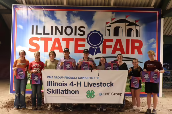 Winners pose with a banner.