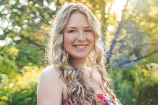 Ellis Rogers poses in a tree setting.