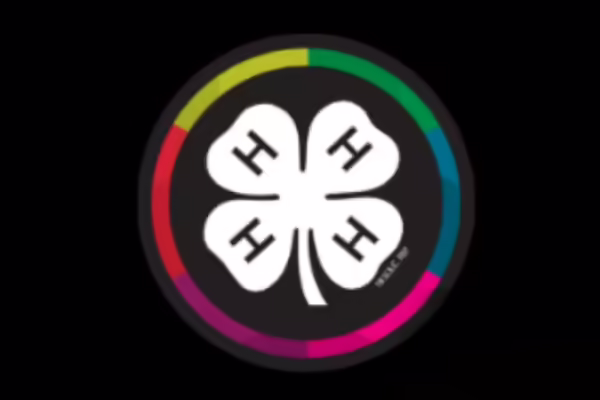 Black background, rainbow circle, 4-H clover emblem in center