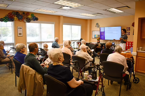 Crowd of class participants listen to presentation on signs of Alzheimer's