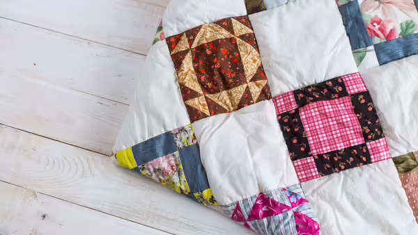 A quilt with different patterns of quilt squares