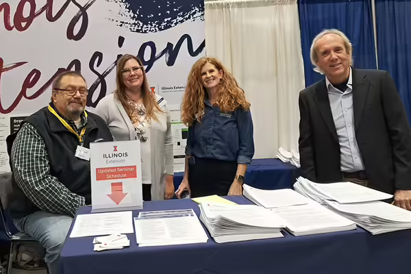 four people at a display booth