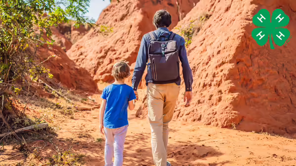 boy and adult walking in the desert