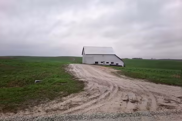 a rundown barn in a field