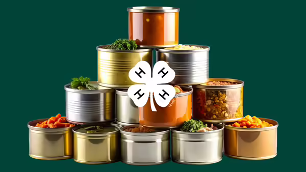 stacked canned food items with white 4-H clover