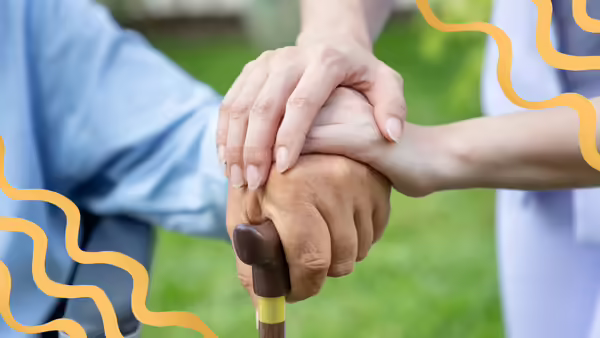 A caregiver holding a senior citizen's hand with curvy lines for decorations.