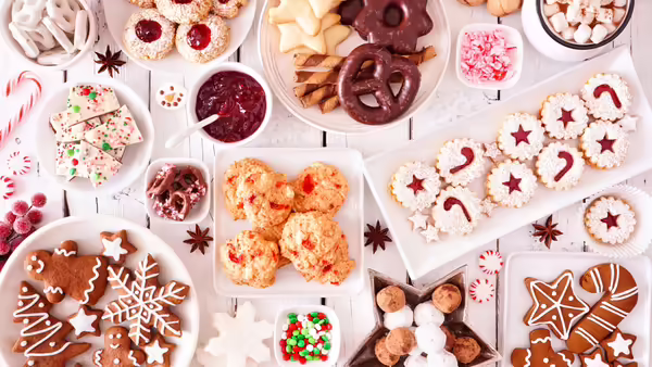 Varieties of holiday baked goods/treats on plates and in bowls