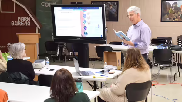 a man presenting in front of a screen