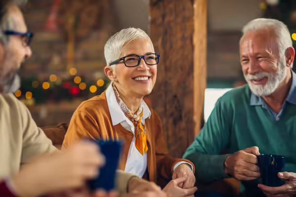 older adults smiling at a holiday party