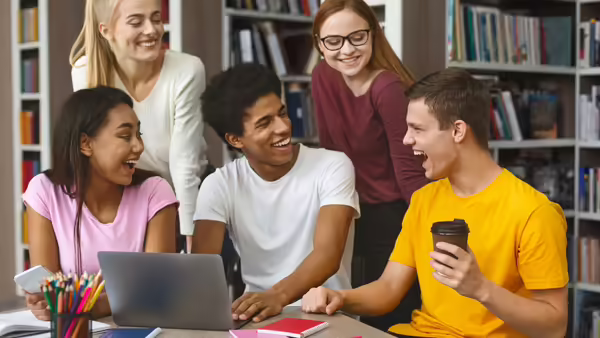 Enthusiastic teenagers sharing ideas with each other at a library