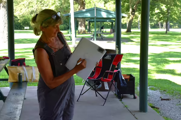 Participant demonstrating nature journaling ideas at the park outdoors 