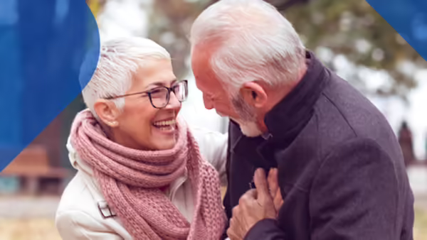 Older couple hugging and smiling