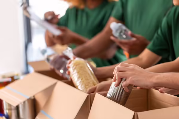 People putting food donation in a box