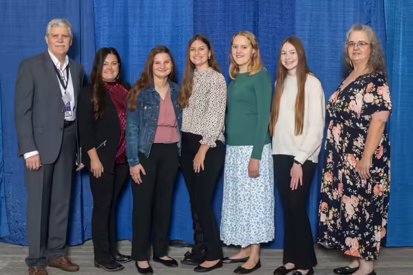 Winning members pose with their coaches.