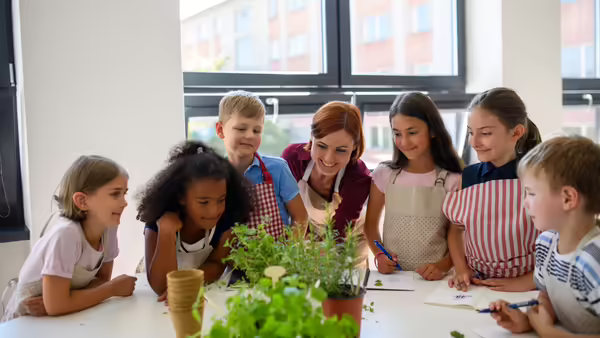 youth and an adult looking at plants together