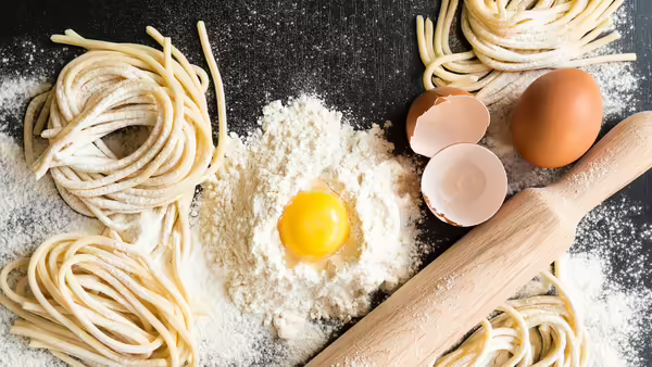 flour, eggs, rolling pin, and homemade noodles