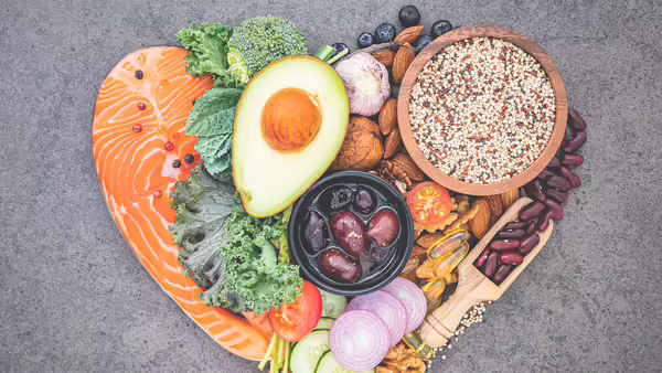 A display of fruits, vegetables, and healthy food in the shape of a heart.