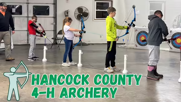 4-H members line up to safely practice archery skills