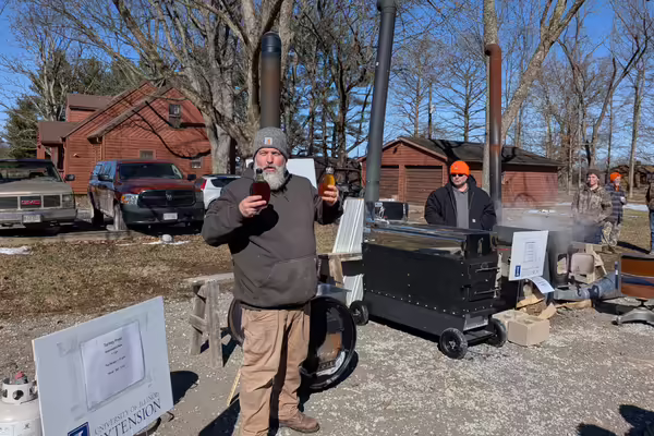 Extension Forester Chris Evans shows off homemade maple syrup at a workshop.