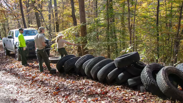 trash blast participants removing tires