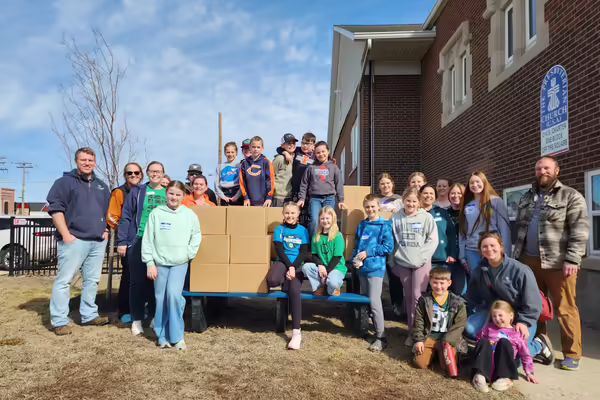 4 H members and their families after meal packing event