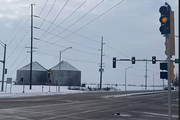 stop light with grain bins in the background