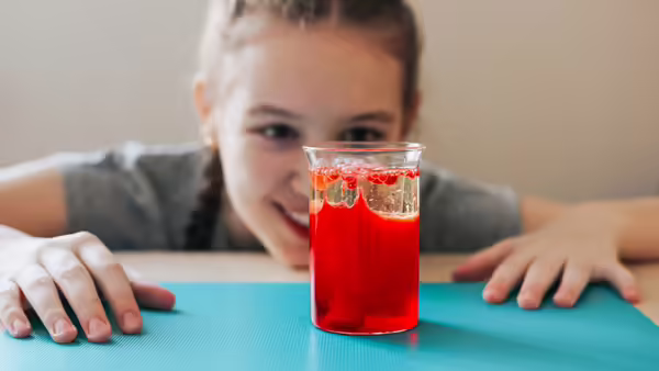 a young girl looking at a homemade lava lamp