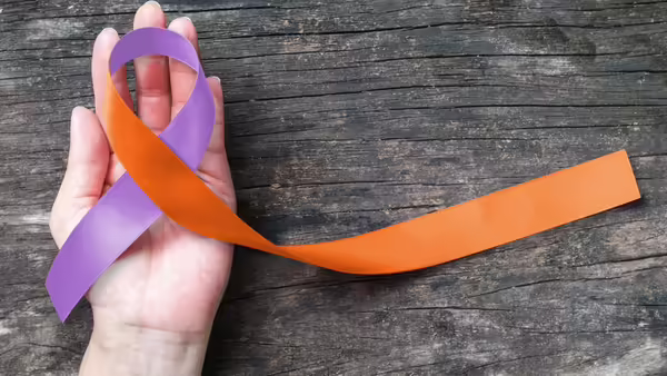 A purple and orange ribbon to represent arthritis awareness.