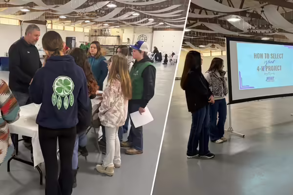 A group of 4-H members stand at a table with a presenter, while a group of people present from a screen that reads: how to select your 4-H project