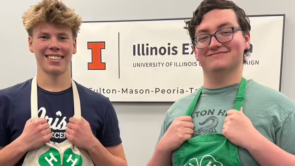 two teen boys with aprons on