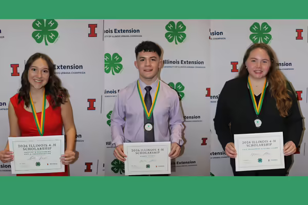 Winning scholarship youth pose with a certificate.