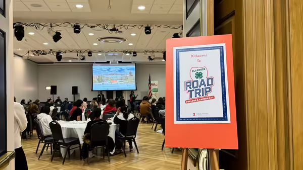 college and Career Road Trip sign displayed outside of a room with youth learning. 