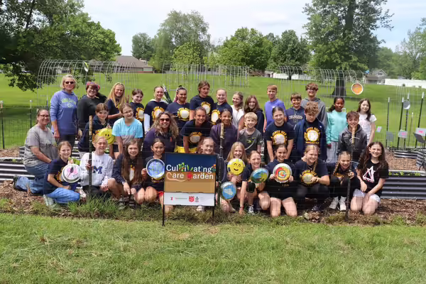 A large group of kids and adults who helped prepare the cultivating care garden.