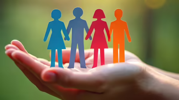 paper people standing on an open hand