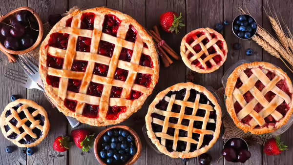 Five different types of pies with lattice crusts.