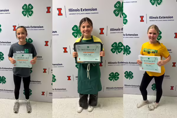 Three of the winners pose with their certificates.