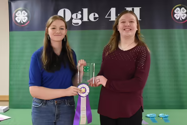 Two youth holding a ribbon