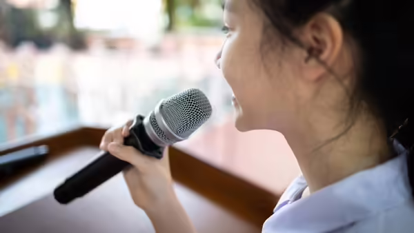 A girl speaking into a microphone.