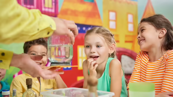 A group of children looking at a science experiment 